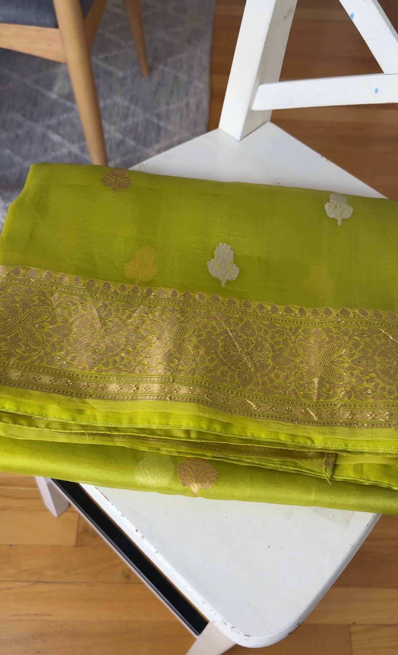 Lustrous zari pallu of chartreuse Ektara Kora Banarasi saree with intricate woven detailing
