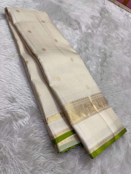 Pure Kanjivaram silk saree in soft ivory with traditional zari pallu