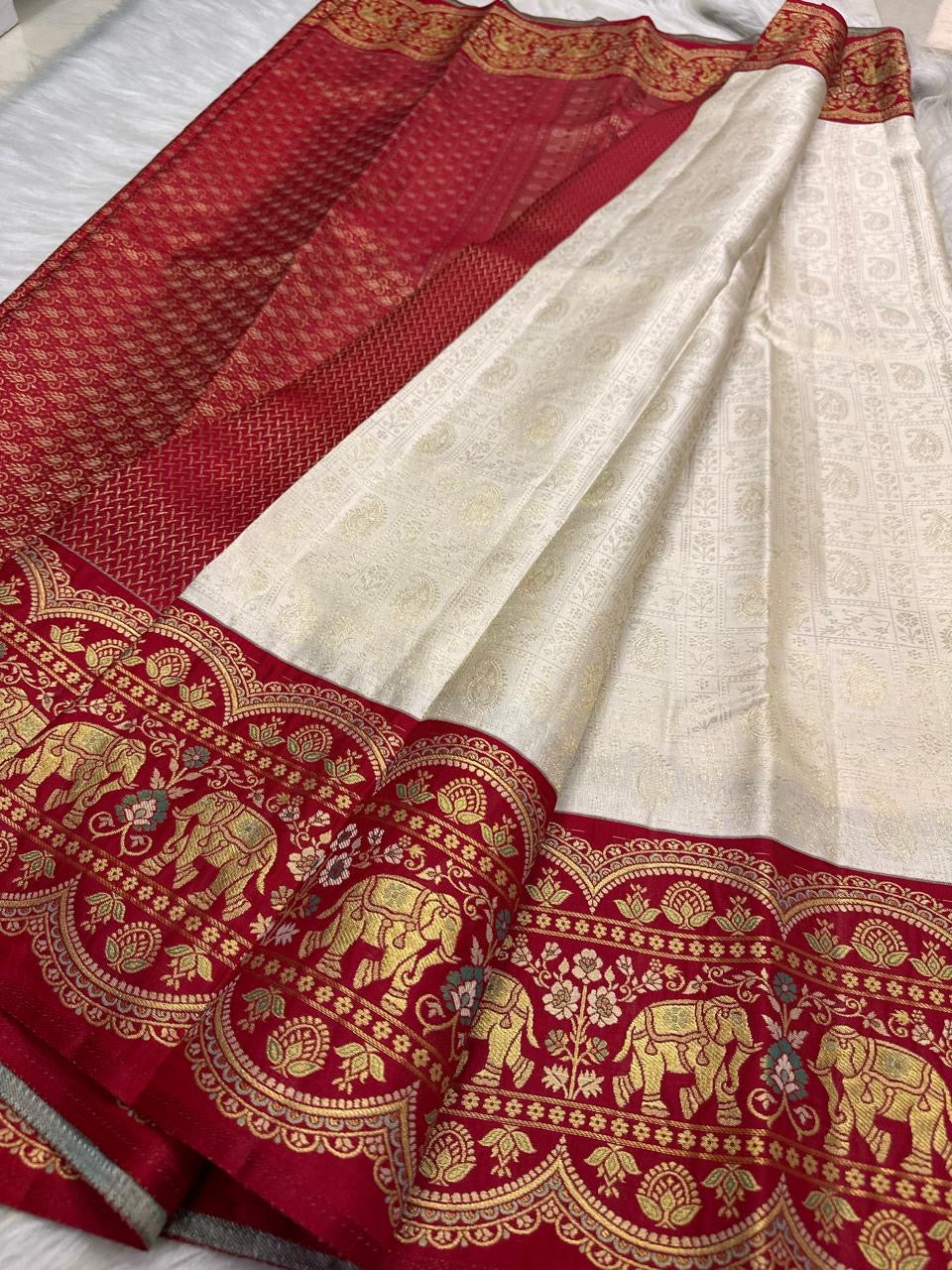 Handwoven elephant motifs within ornate zari border on Kancheepuram saree