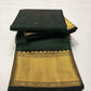 Draped Emerald Green handloom Chanderi saree showing petite gold buttas and expansive antique-gold woven pallu.