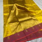 Turmeric yellow Chanderi saree laid open showing the raspberry pink border and rich golden pallu