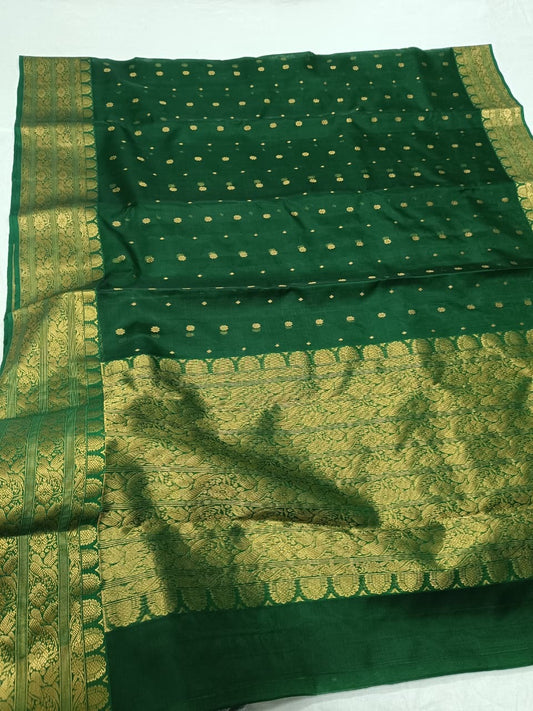 Close-up of Emerald Green Chanderi Katan Silk saree body showing small spaced gold-toned woven accents