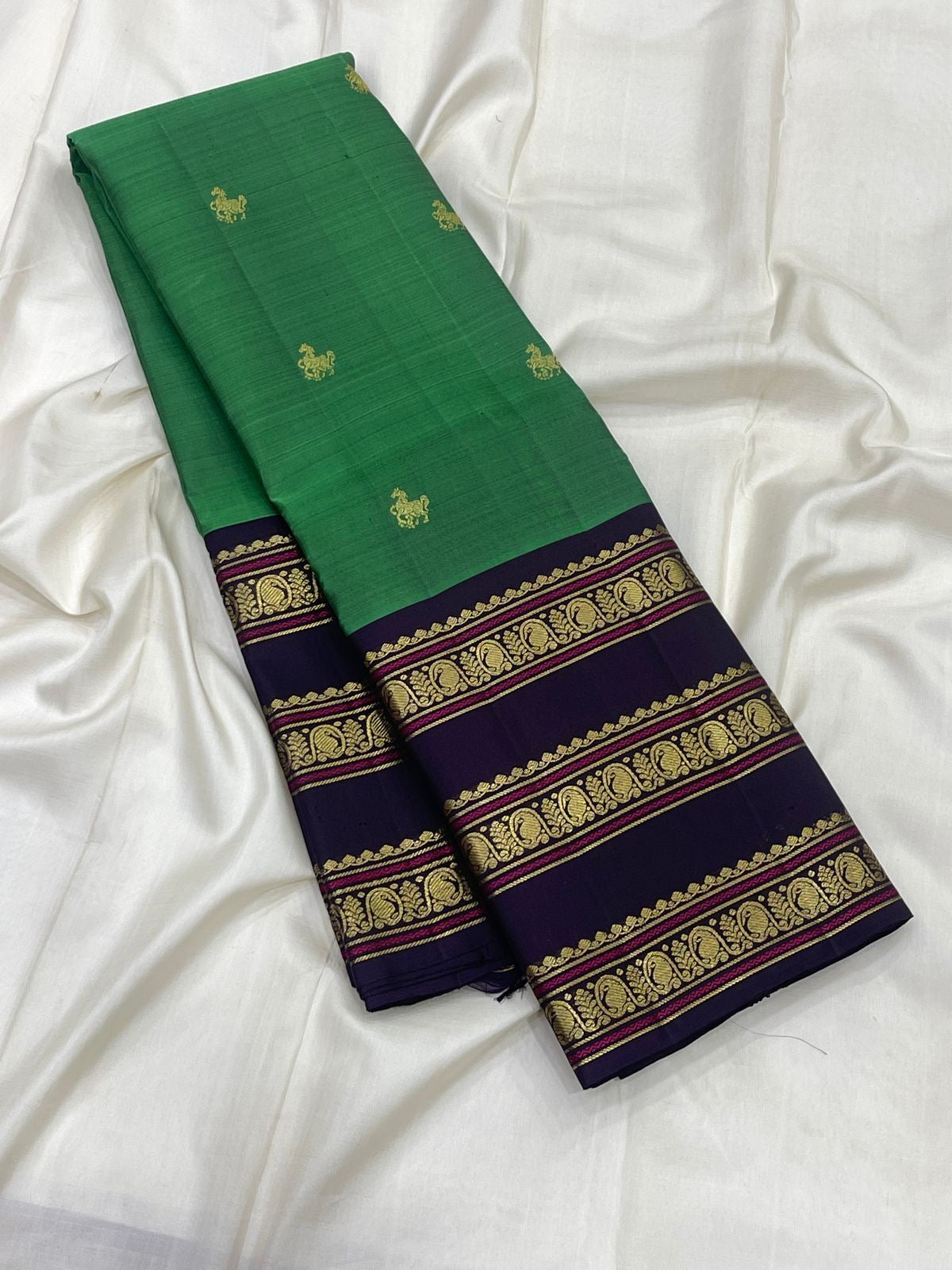 Emerald Green Kanchipuram silk body with small spaced gold zari buttas.