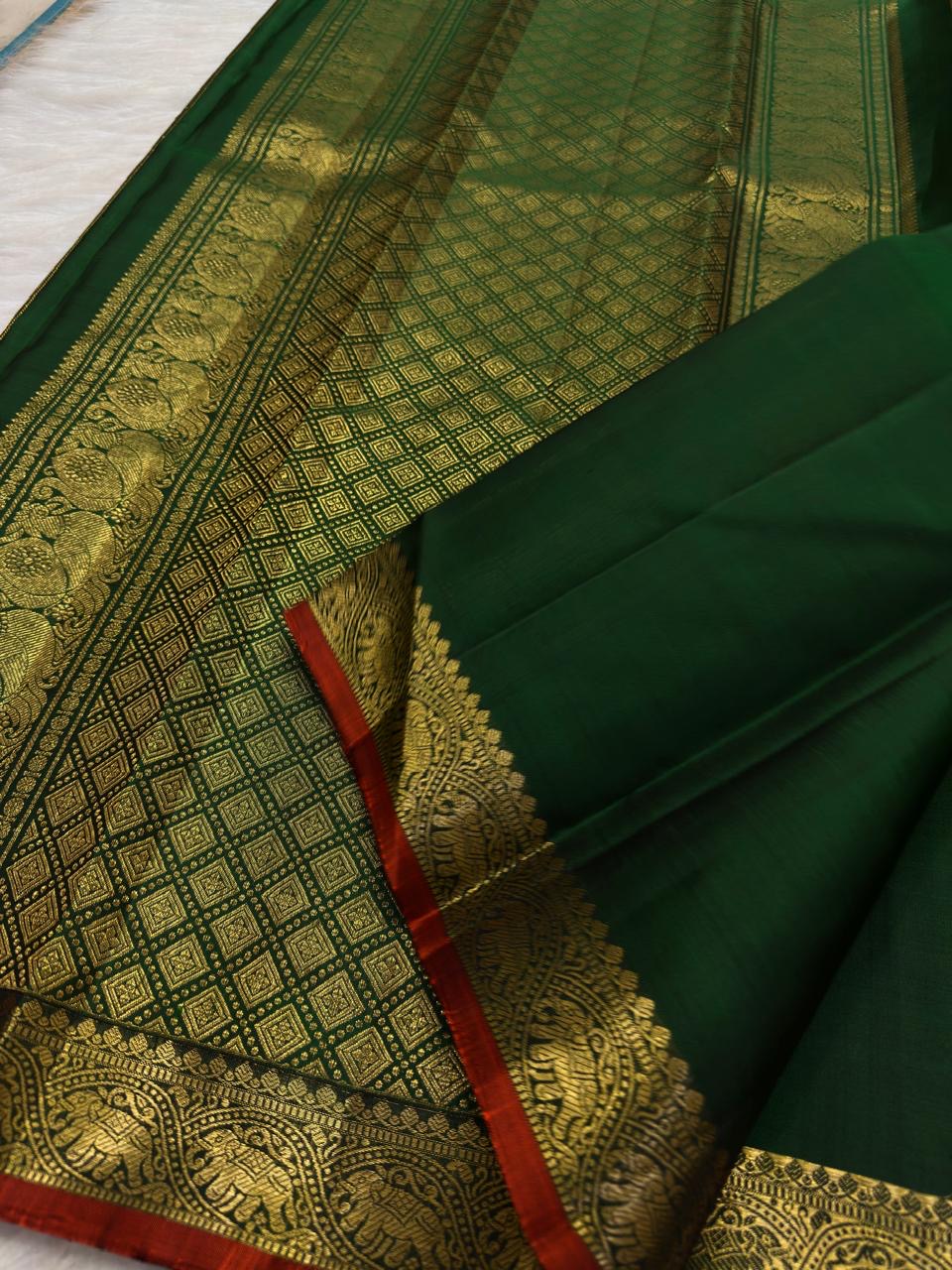 Traditional elephant motif border in antique gold on Deep Emerald Green Kanjivaram saree.