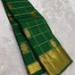Deep Emerald Green Kanchipuram silk saree with antique gold Zari Kattam grid and broad zari border, full drape view.
