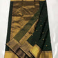 Deep Emerald Green Katan Silk Chanderi saree showing the broad antique-gold woven border with geometric and floral detailing.