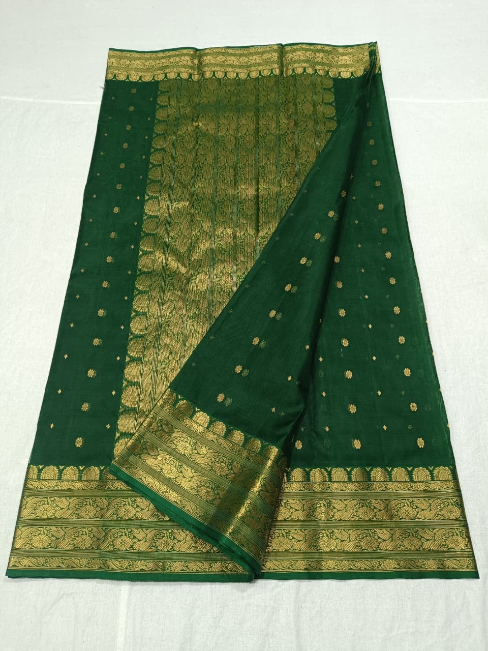 Emerald Green Handloom Chanderi Silk saree draped to show its fluid Katan Silk fall