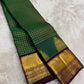 Emerald green Kancheepuram silk saree with purple double border and tree motif — Idam Living