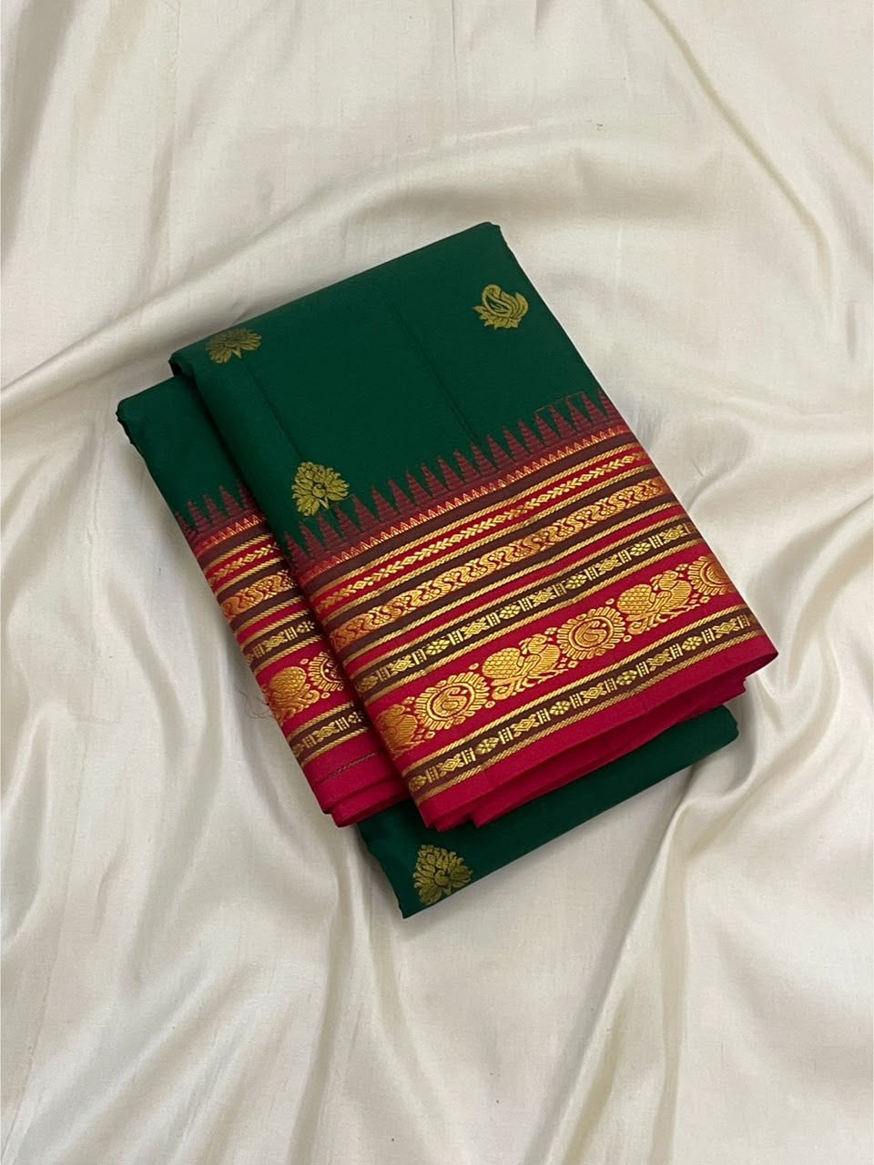 Emerald Green Kanchi Pattu saree with traditional Seer bands and Vanki temple edge