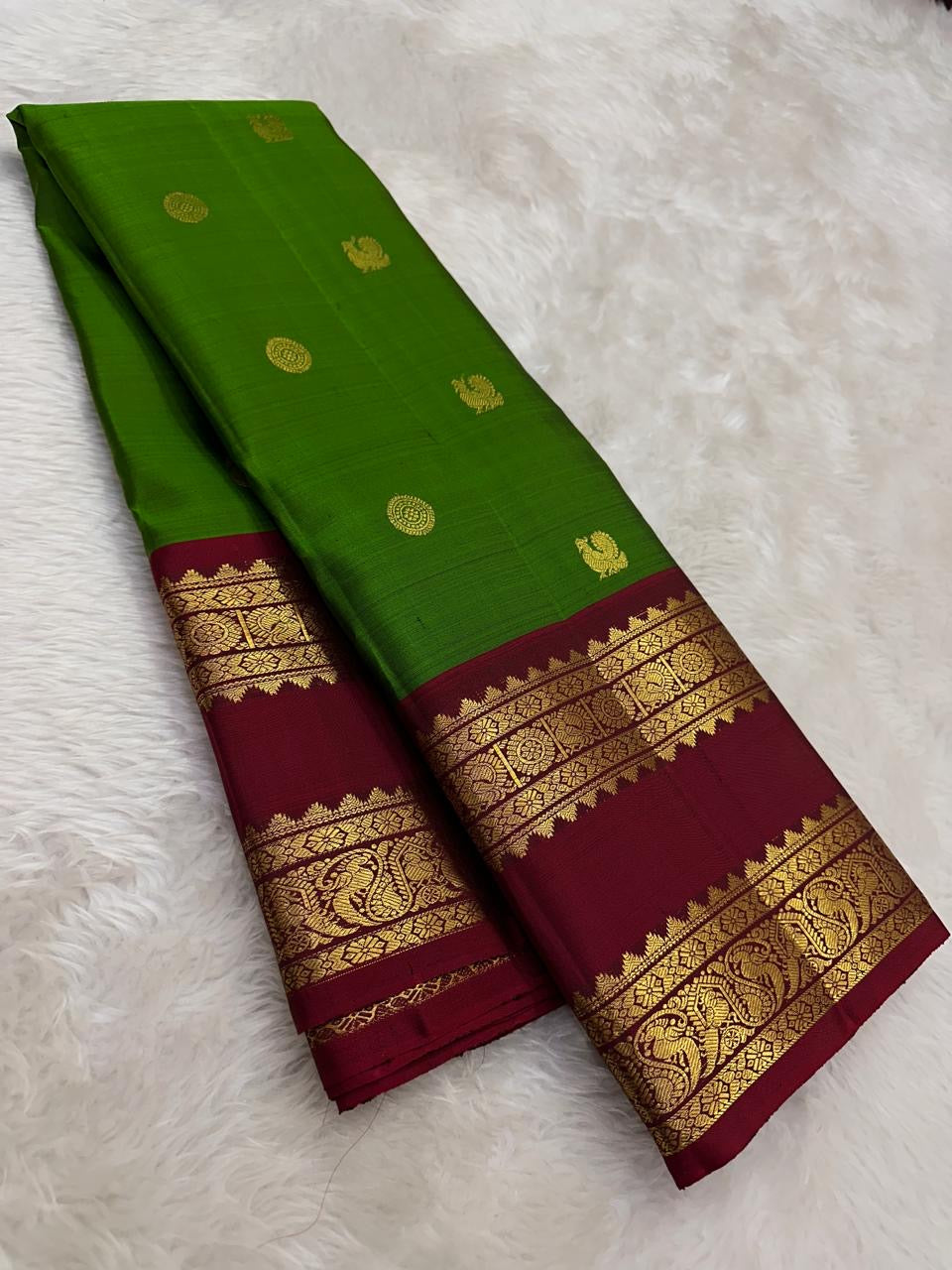 Emerald green Kanchipattu silk saree with ruby rettapet border and gold zari Idam Living