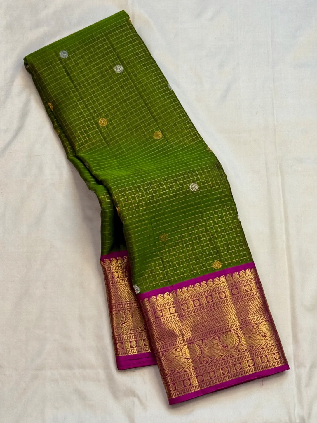 Emerald olive green Kanchipuram pure silk saree with Zari Kattam and Sona Rupa buttas