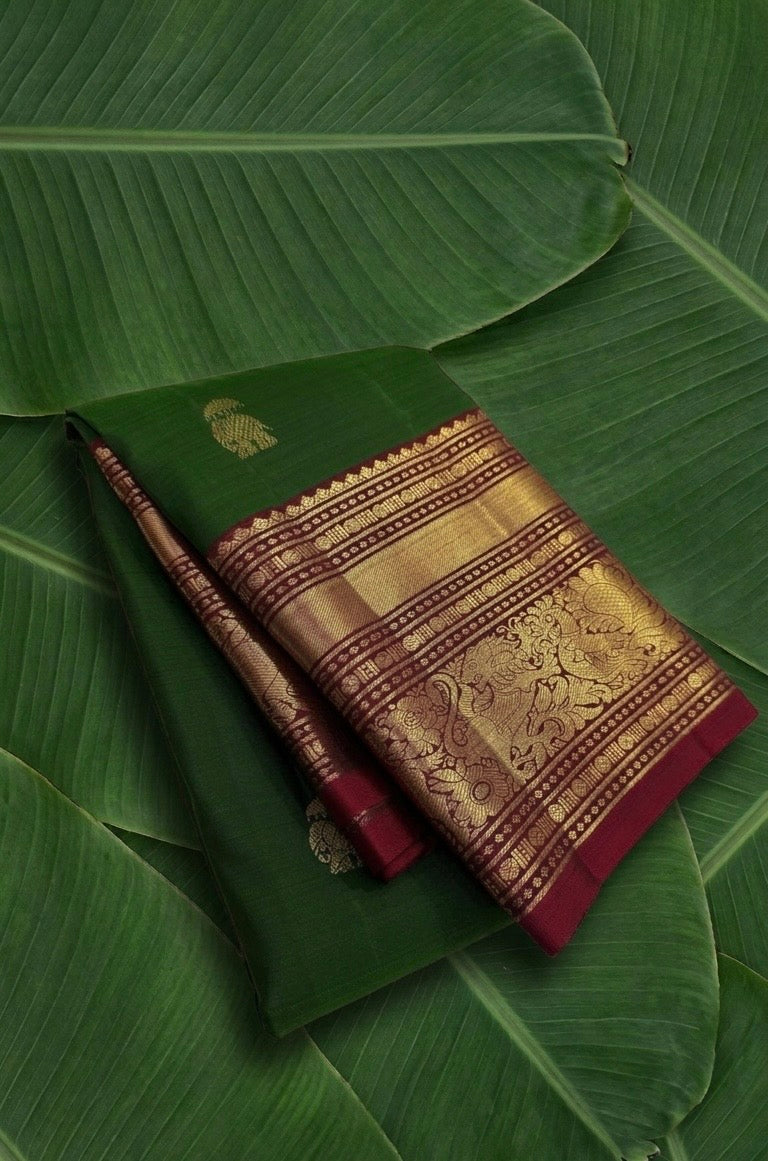 Pure Kanjivaram silk saree emerald green with burgundy red korvai border and yaanai ambari butta – front drape view