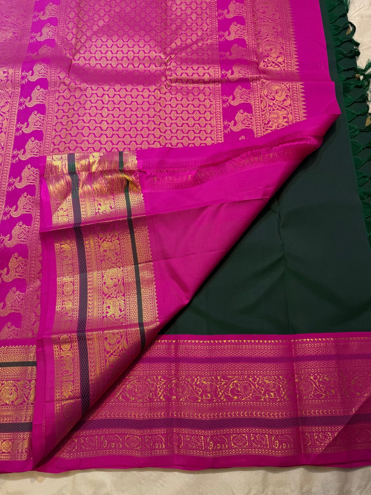 Folded view of emerald green and magenta butta Kanjeevaram silk saree with vanasringaram pallu — Idam Living