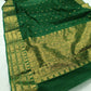 Emerald Green Pure Silk Chanderi saree arranged to show the emerald body and woven gold accents