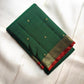 Deep Emerald Green pure silk Kanchipuram saree with antique-gold woven detailing.