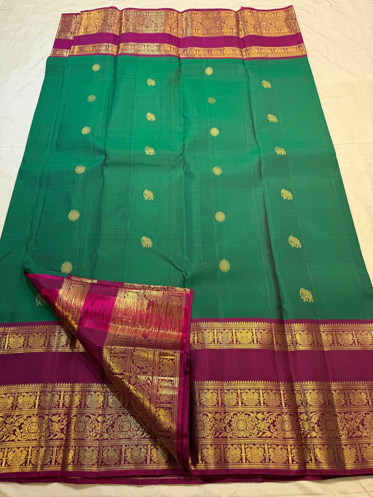 Emerald Pachai Green and Rani Pink handwoven pure silk Korvai saree by Idam Living.