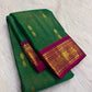 Raspberry-pink peacock border detail, emerald-green KanchiPattu saree