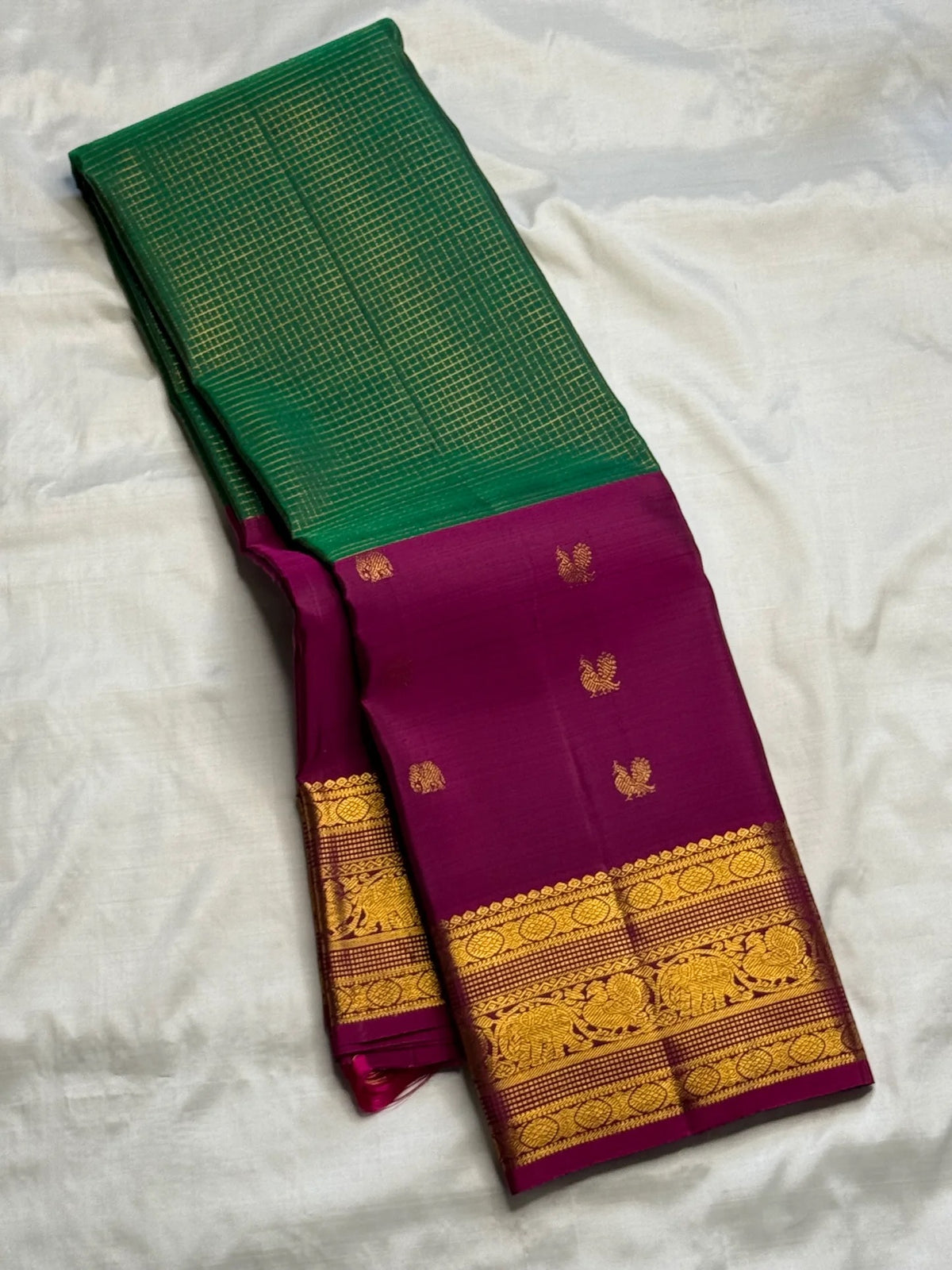 Emerald Pachai Green pure silk Kanjeevaram Korvai saree with Rani Pink gold zari border.