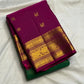 Radiant green Kanchipuram silk saree with alternating Yaanai and Chakram gold zari buttas.