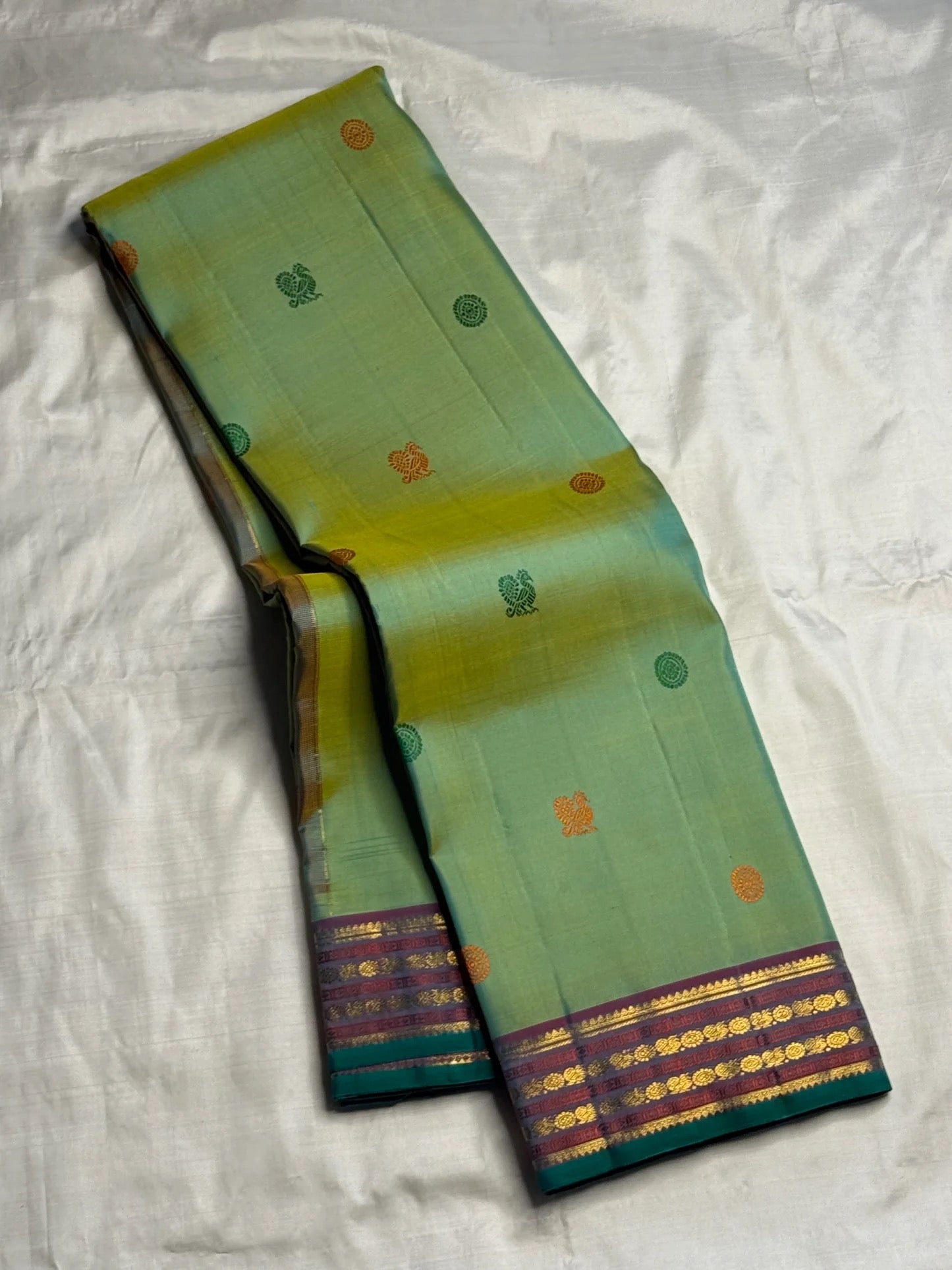 Emerald and Parrot Green Shot Colour Handwoven Pure Silk Kanchi Pattu Saree with Mayil Chakram Butta and Korvai Border