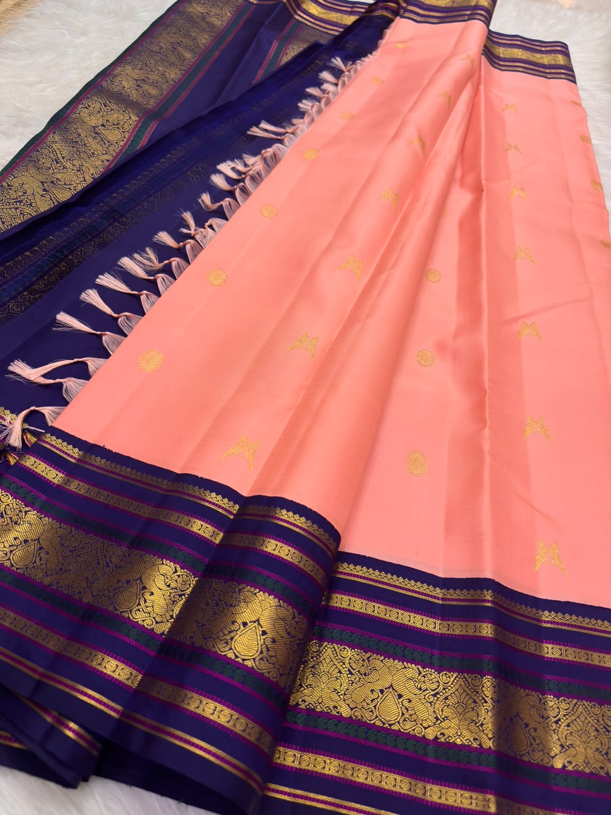 Erattai Kili and Kamalam lotus buttas in gold zari, coral-pink Kanjeevaram saree