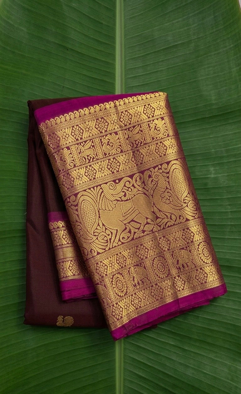 Pure Kanchipuram Butta silk saree in espresso brown with Yazhi motif zari border and rani pink selvedge