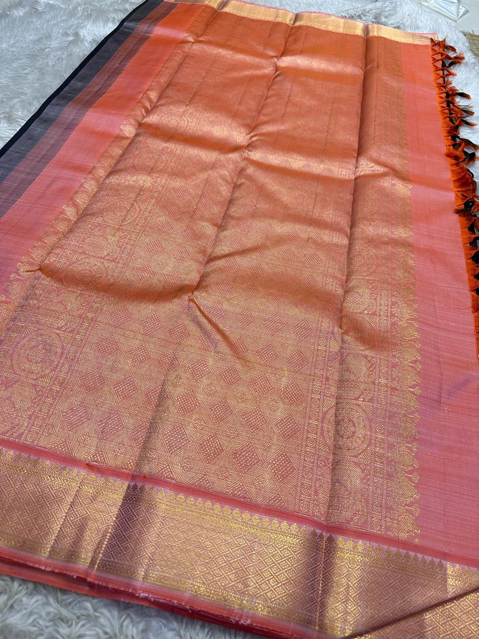 Partially draped purple black pure Kanchipuram silk saree highlighting contrast between body and heavy zari-work borders.