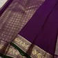 Close view of purple pallu with dense gold zari woven geometric grid and ornate border detailing.