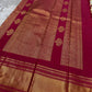 Wide pallu display of a Pure Kanchipuram silk saree with tomato red panels and gold zari woven motifs, shipped from New Jersey USA.