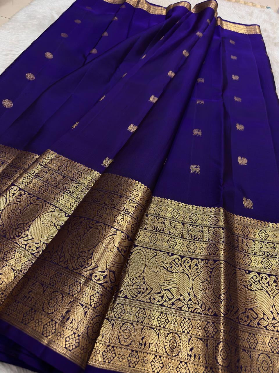 Traditional Kanchipuram saree in regal indigo blue with temple-inspired Yazhi motif weaving