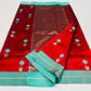Folded Vermilion Red Chanderi saree showing the Aqua Blue floral buttas and contrast border