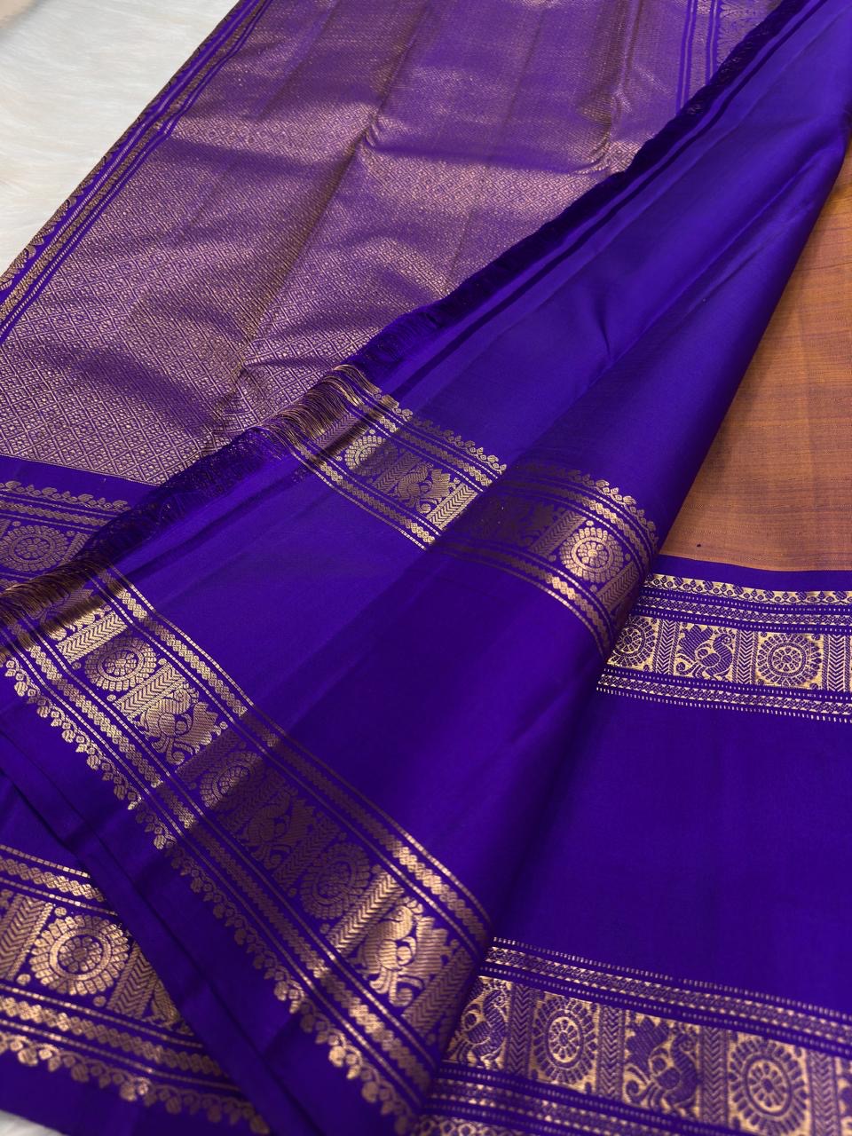 Shimmering narrow zari filaments woven in parallel lines on pure Kanchipuram silk