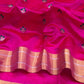 Close view of the rani pink Chanderi body with small gold-toned and green floral buttas