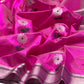 Close-up of a pale flower with dark centre and green leaves on fuchsia Chanderi.
