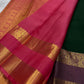 Close detail of flowering kodi-style gold zari creepers and paisley-like forms across dark green silk.