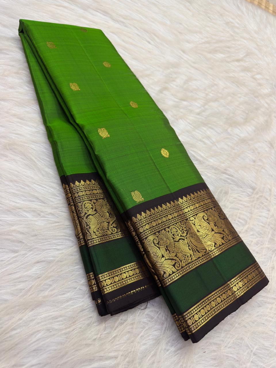 Deep magenta Butta Kanjipuram saree with black-green peacock zari border