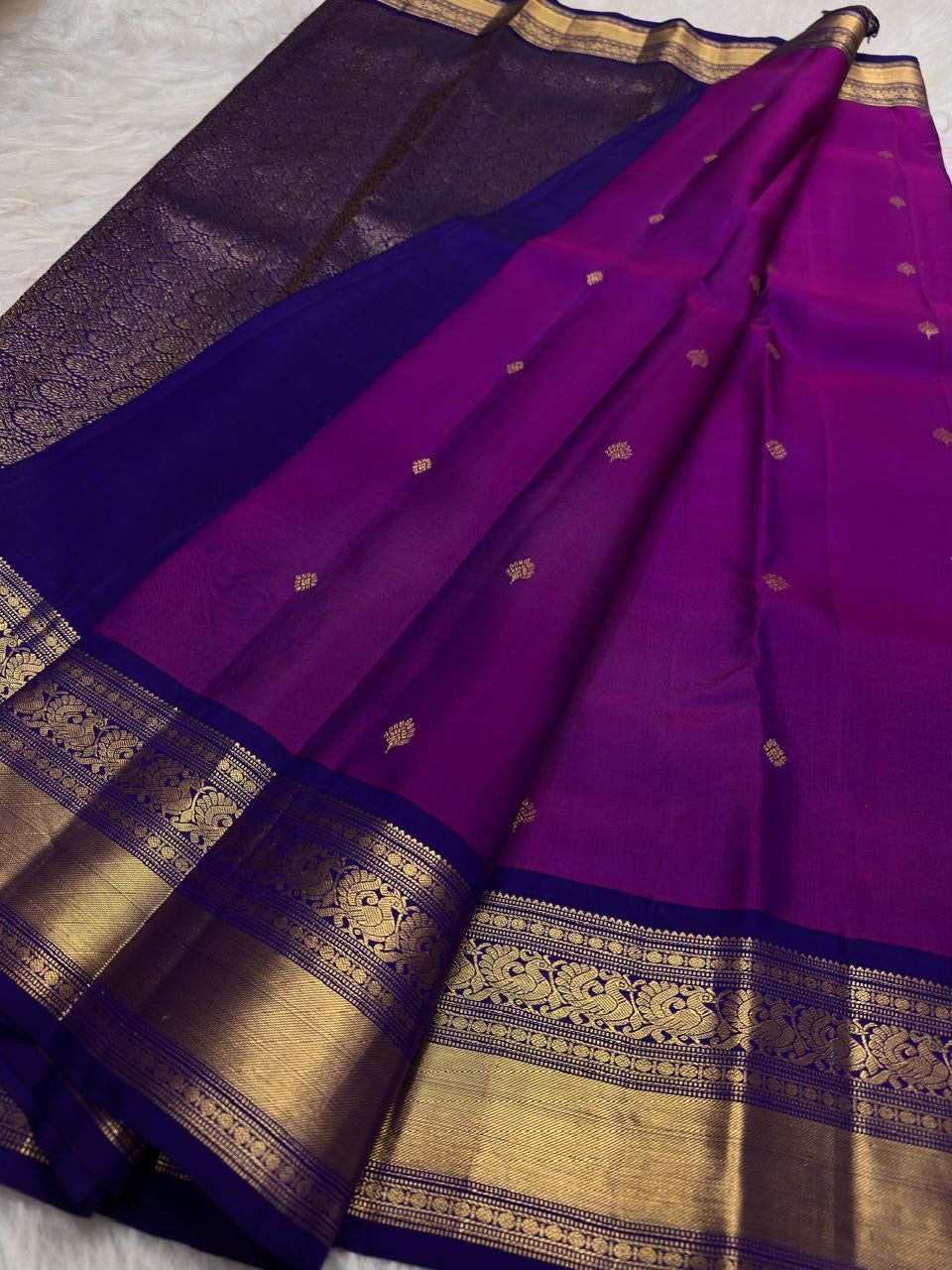 Intricate floral-vine gold zari detailing along the Deep Neelam contrast border.