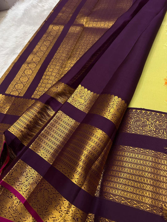Lime chartreuse Kanjipuram silk saree body close-up showing Kudhirai flying horse antique gold zari butta motifs on plain silk ground