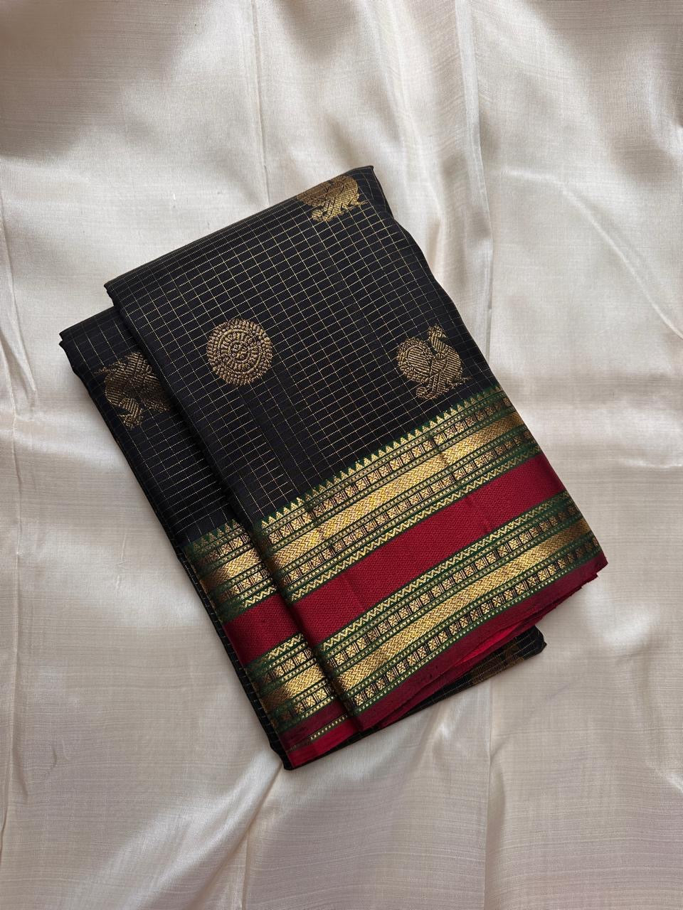 Closeup of maroon pallu with antique gold zari detailing on Kanchipuram silk saree