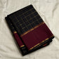 Folded Pure Kanchipuram Silk Saree in black checked weave with wide maroon zari border on ivory backdrop