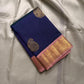 Folded navy Kanchipuram silk saree with gold zari buttas and blush pink zari border