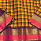 Flat lay of pure Kanchipuram silk saree showing multicolor checked body with purple and gold zari border