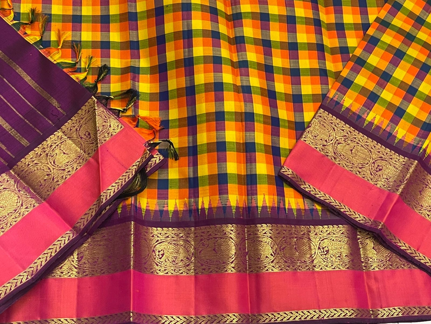 Flat lay of pure Kanchipuram silk saree showing multicolor checked body with purple and gold zari border
