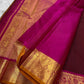 Close view of magenta silk pallu with gold zari woven pattern and matching zari woven border.