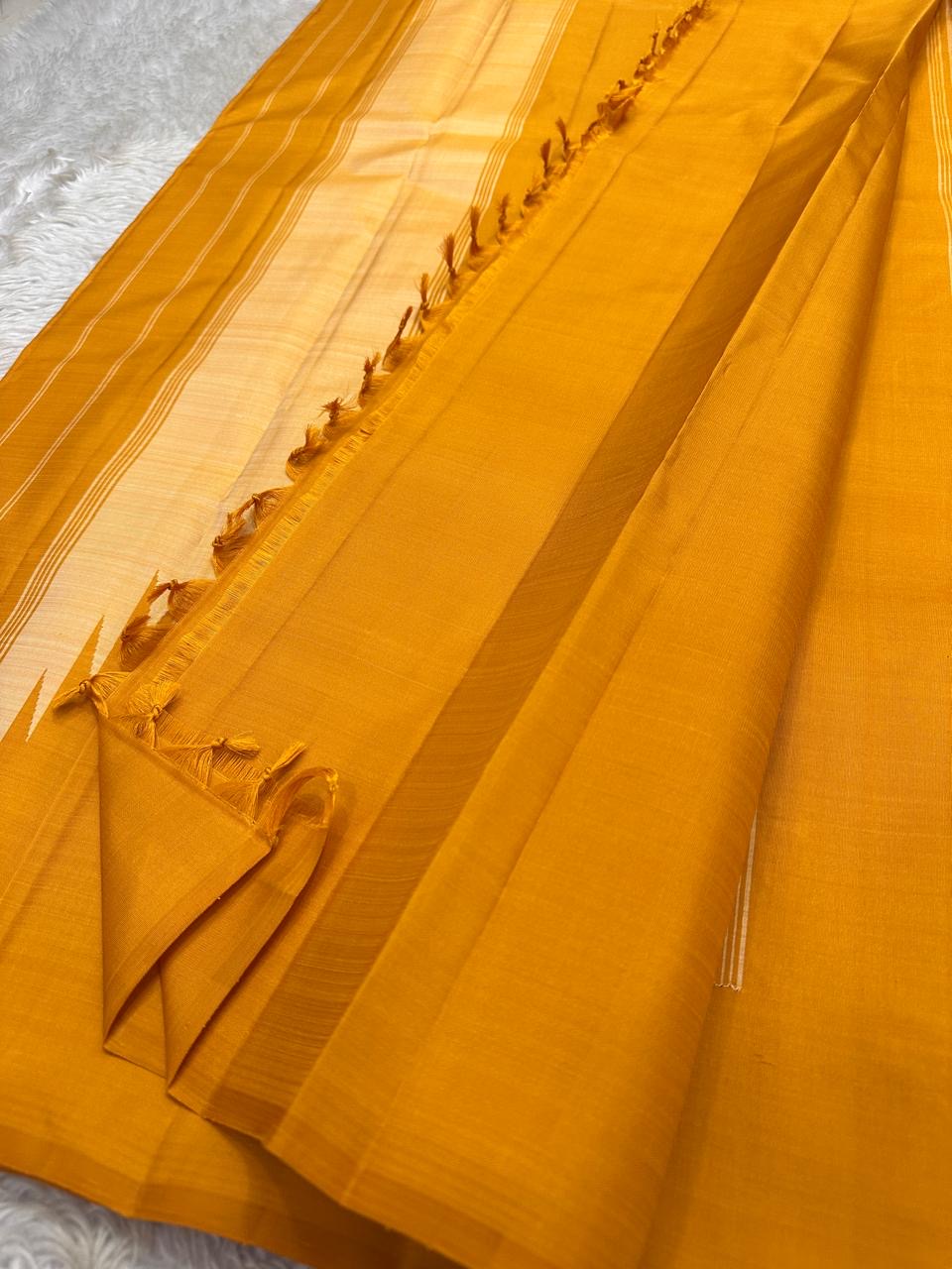 Close view of mustard Pure Kanchipuram Silk Saree with striped pallu section and tassels, shipped from New Jersey USA