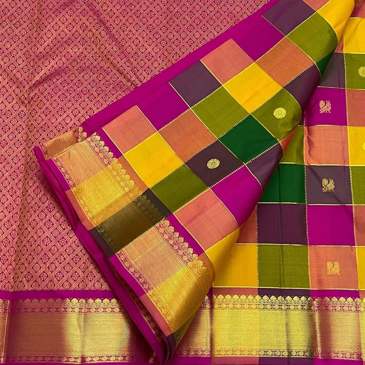 Flat-lay of checked Pure Kanchipuram silk saree beside magenta pallu with zari weave, shipped from New Jersey USA.