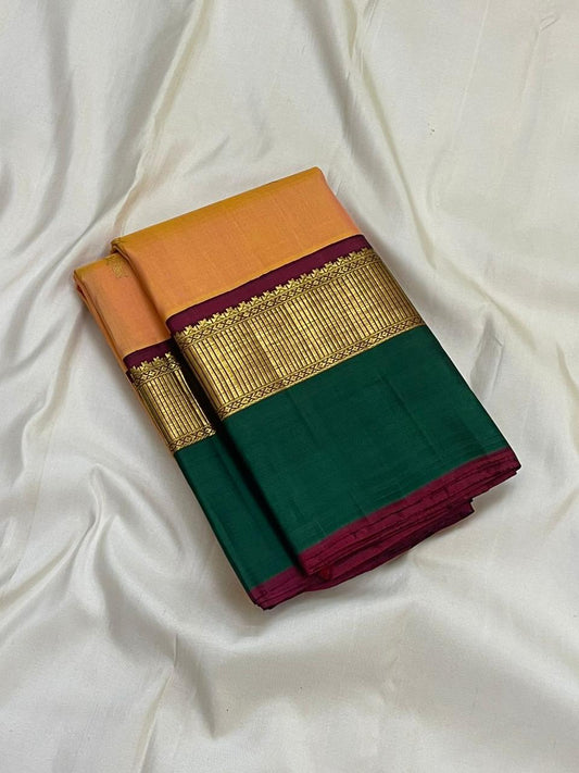 Pure Kanchipuram silk saree folded view showing peach body with subtle butta, green border, maroon selvedge, and antique gold zari detailing