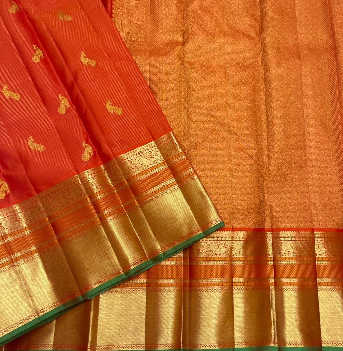 full length view of vermillion orange kanchipuram silk saree with zari pallu available in the USA