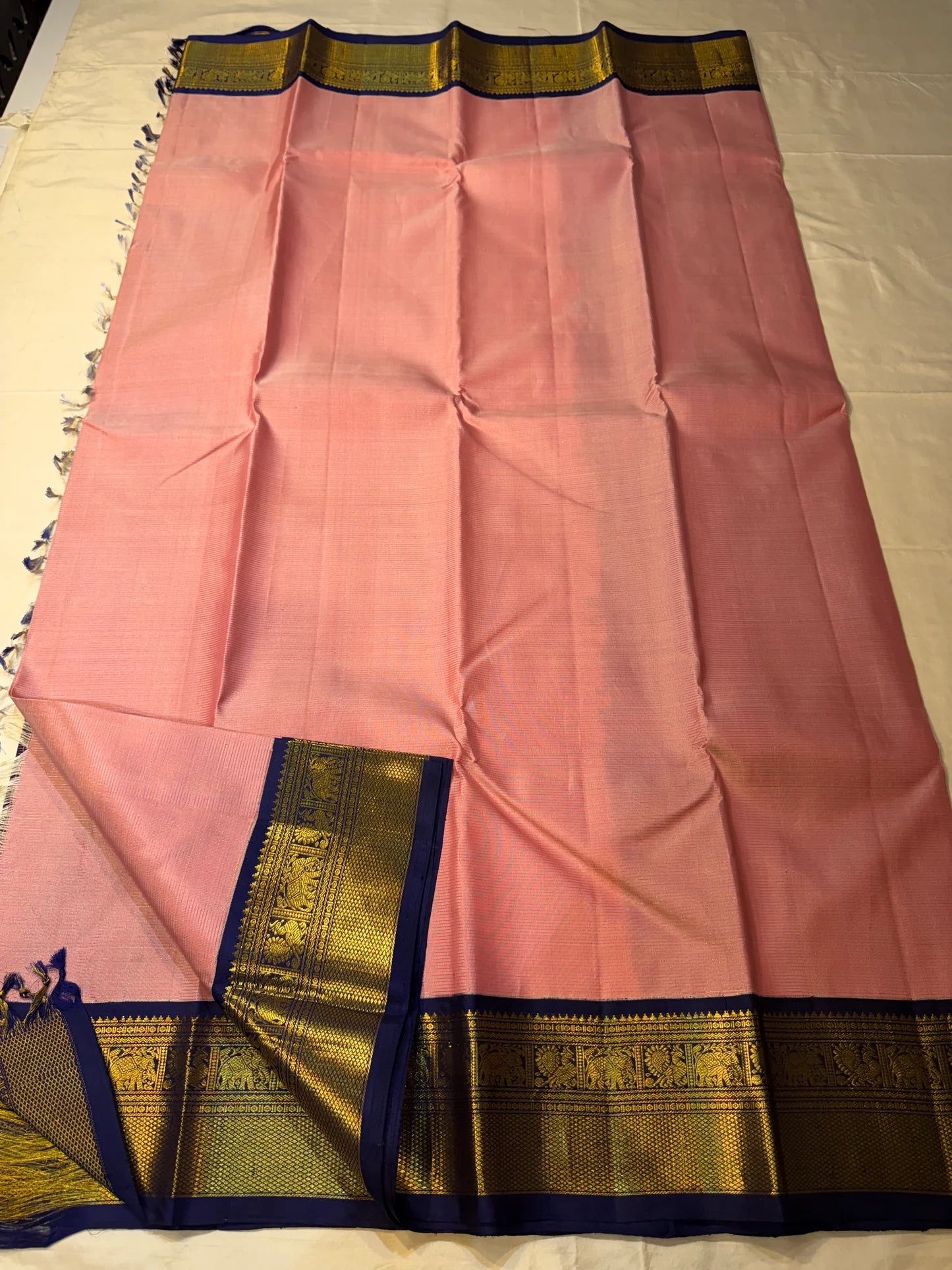 Navy pallu closeup on Kanchipuram silk saree with dense antique gold zari woven pattern and contrast border