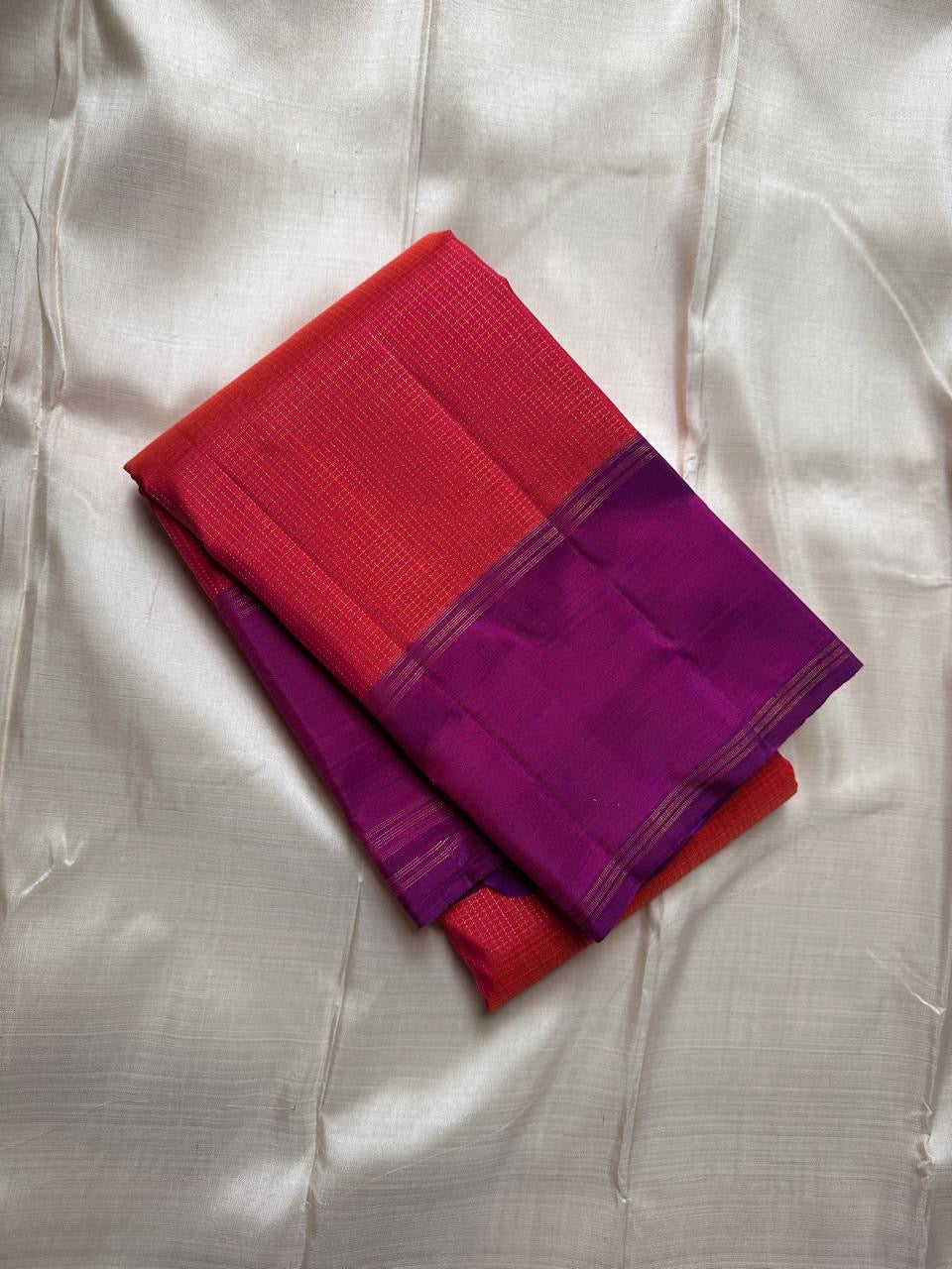 folded coral red pink pure kanchipuram silk saree with deep purple contrast border
